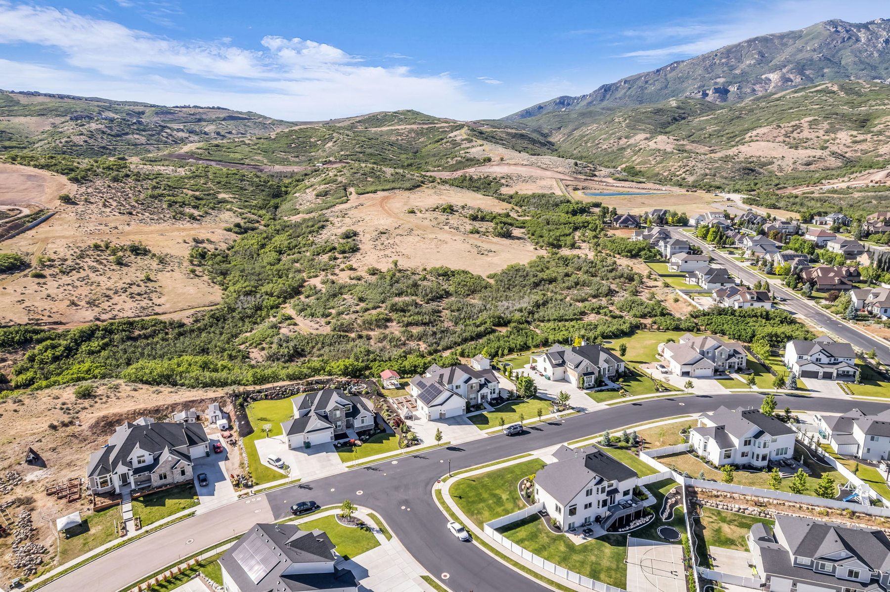 Aerial view of Beach Hill subdivision and 12517 N Minots Ledge Dr Highland Utah with mountain backdrop